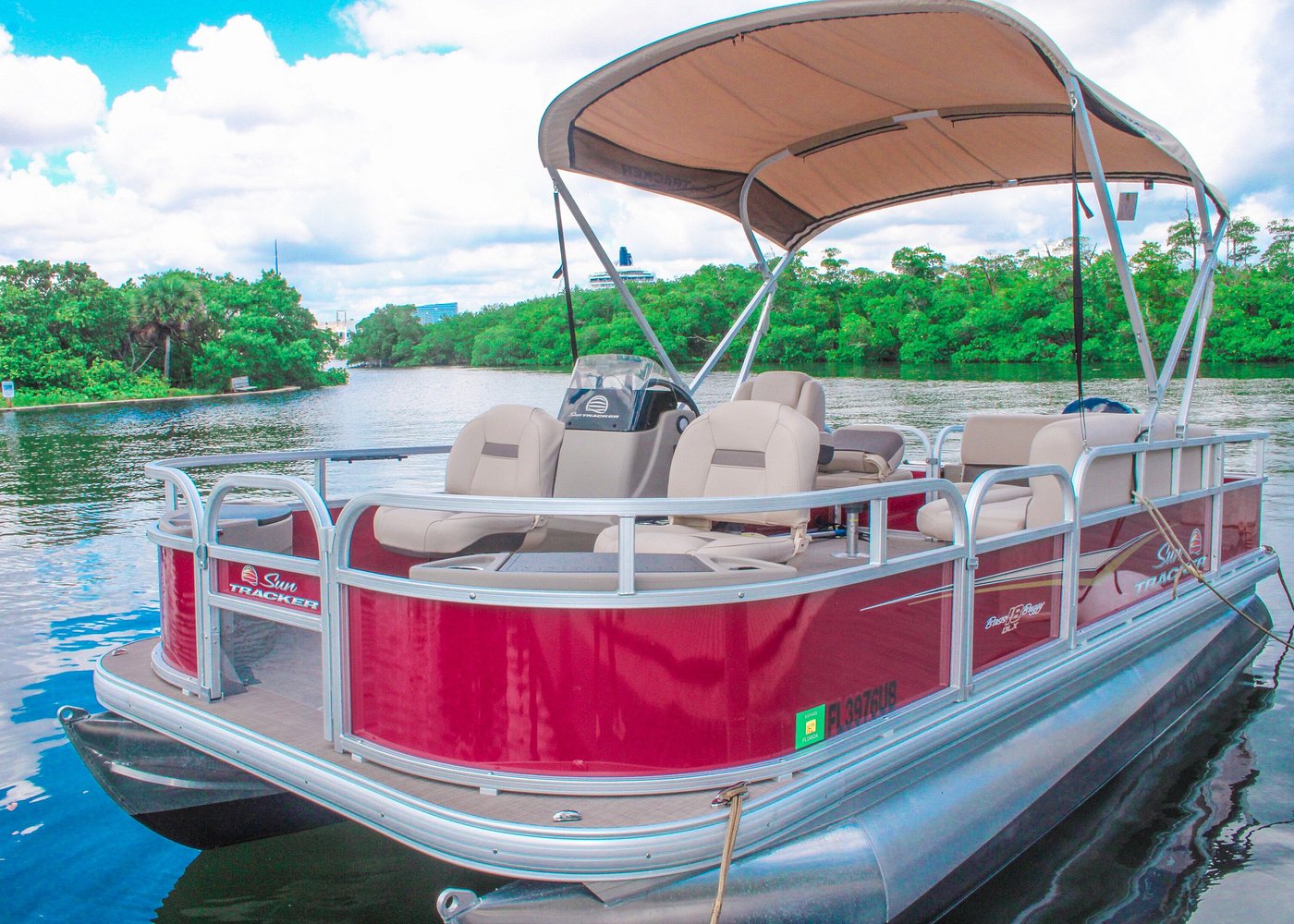 Dania Beach 18ft Pontoon Boat Full Day Rental-1 Red Sun Tracker pontoon boat on calm river with trees